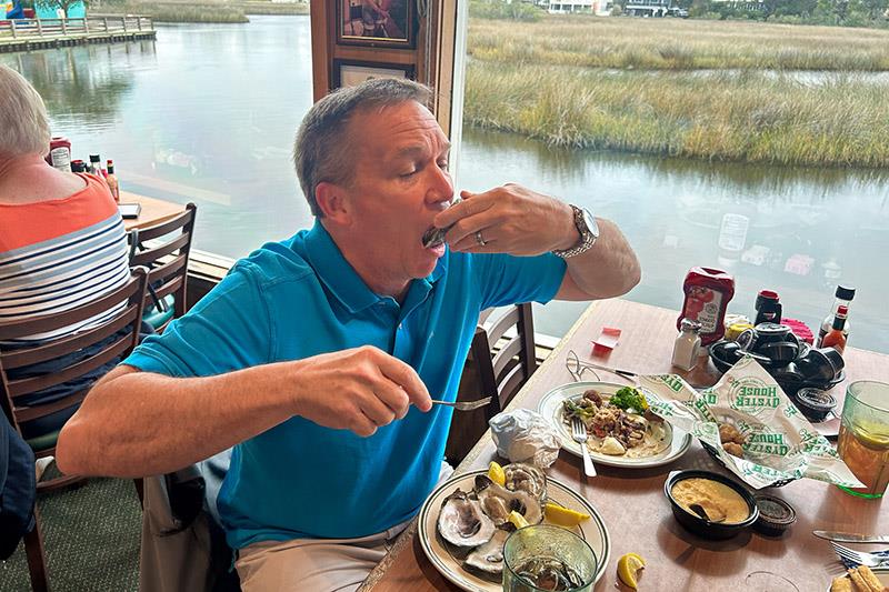 Jeremy Sullivan of Orange Beach, Alabama, enjoys oysters on the half shell at the Original Oyster House in Gulf Shores, Alabama photo copyright Original Oyster House taken at  and featuring the Fishing boat class