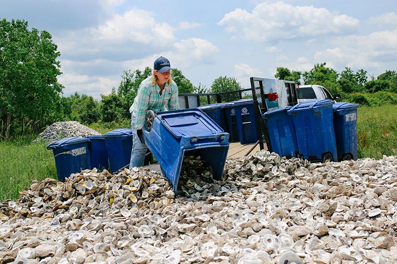 Unloading oyster shells collected from restaurants to cure in the sun photo copyright Galveston Bay Foundation taken at  and featuring the Fishing boat class