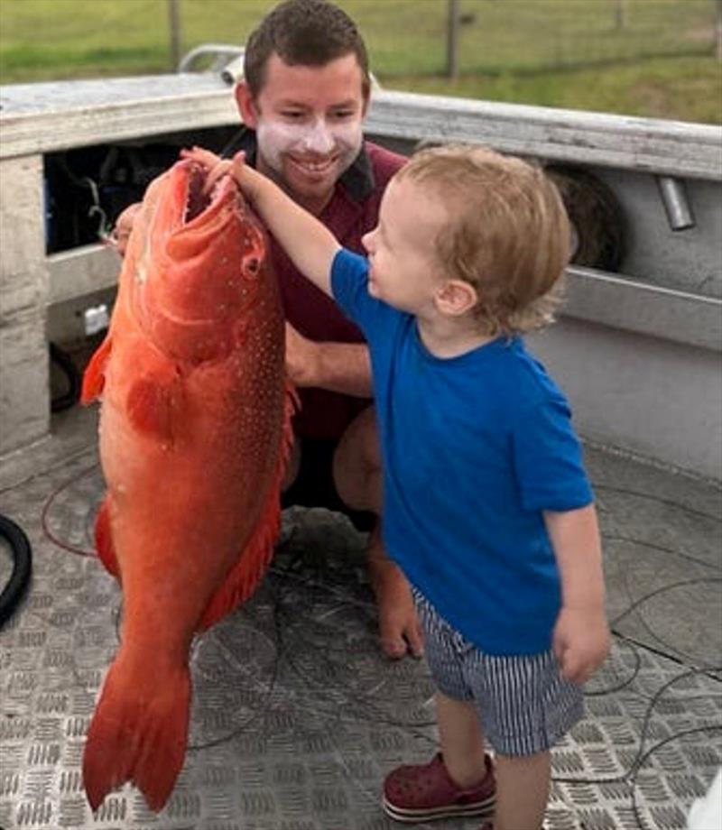 Get them hooked young! Kurtis sharing another fantastic father son moment with Tommy as he shows of this bar-cheek coral trout - photo © Fisho's Tackle World