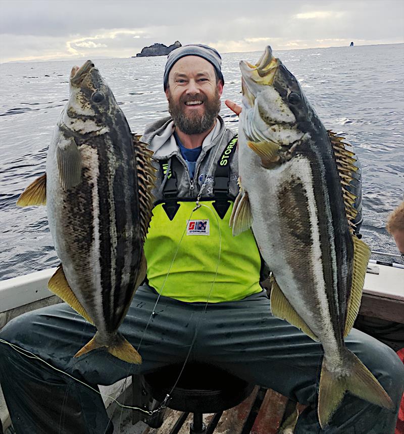 Leo Miller with two Tasmanian striped trumpeter - photo © Carl Hyland