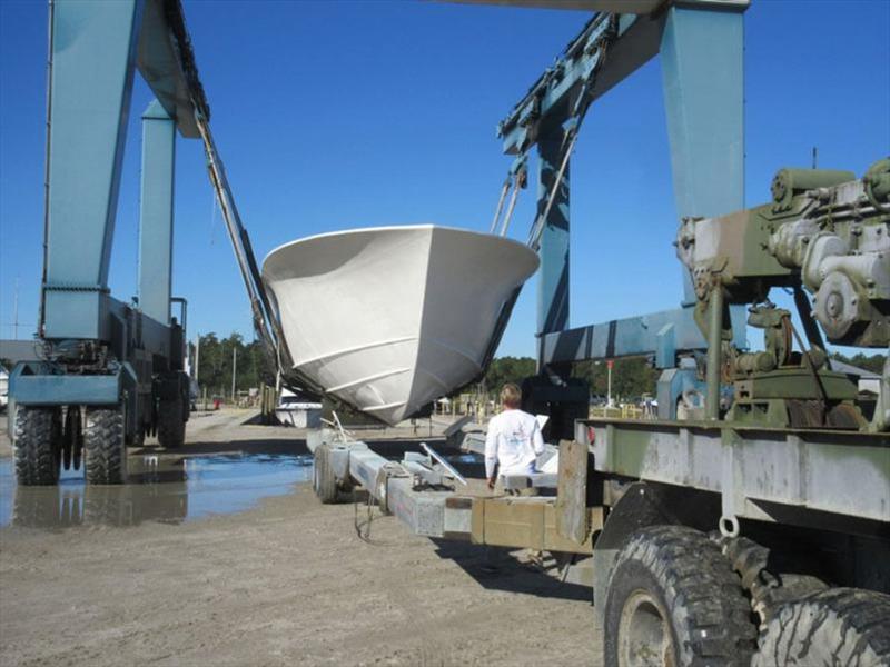 Hull 65 is flipped right side up and loaded on a trailer to return to her construction building - 64' Custom Sportfish photo copyright Jarrett Bay Boatworks taken at  and featuring the Fishing boat class