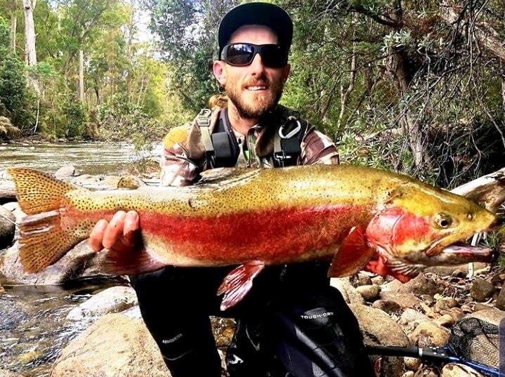 Jason Hales with a wild  Tasmanian Rainbow trout - photo © Carl Hyland