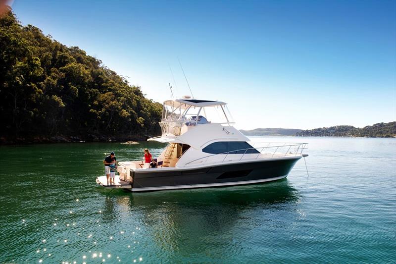 Relaxing in a secluded bay aboard the Riviera 43 Open Flybridge photo copyright Riviera Studio taken at  and featuring the Marine Industry class