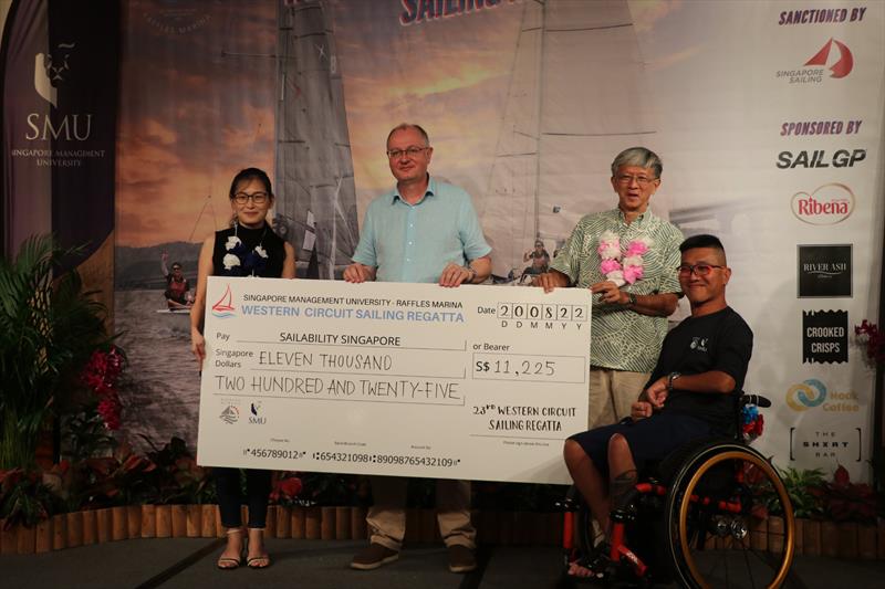 Presentation of cheque to Sailability Singapore photo copyright Raffles Marina taken at 