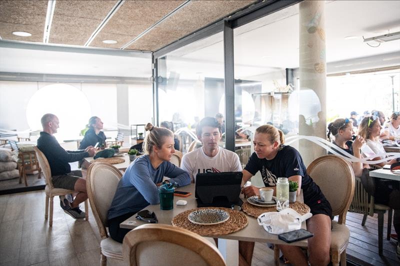 Stephanie Roble and Maggie Shea meet before racing with USST 49erFX Coach Evan Aras in the cafe near the 49erFX boat park photo copyright US Sailing Team taken at Real Club Náutico de Palma