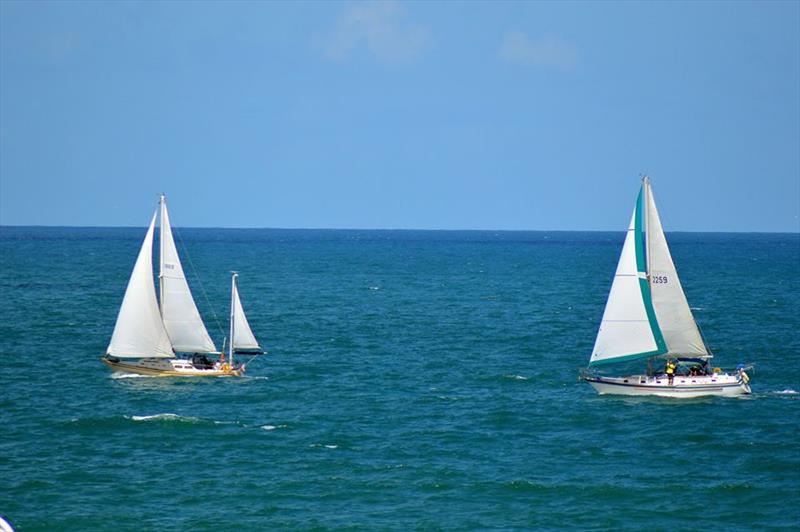 Yachts competing in the Gulfstreamer pass the Daytona Beach Main Street Pier en route to the finishing line off of Charleston, South Carolina photo copyright GulfStreamer Offshore Sailboat Challenge taken at Halifax River Yacht Club and featuring the PHRF class