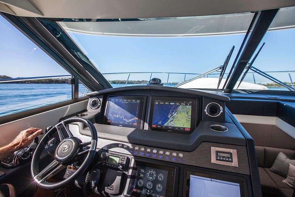 Off we go! Command position is well positioned and there is a plethora of material available from the three main displays. - Riviera 4800 Sport Yacht ©  John Curnow